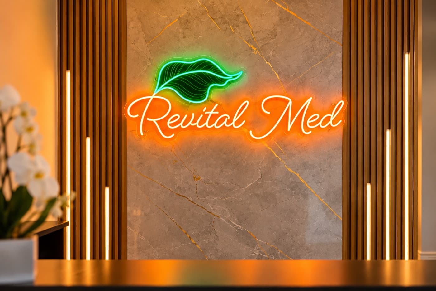 The glowing Revital Med neon sign at the Revital Med Spa front desk